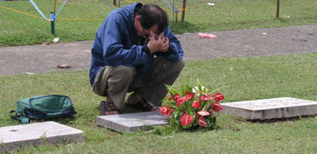 A man mourns at the Davao Memorial cemetery. (Photo by Barry Ohaylan)