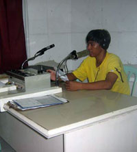 The radio booth Pace used to occupy, shown here with a colleague of the victim's. (davaotoday.com photo by Germelina Lacorte)