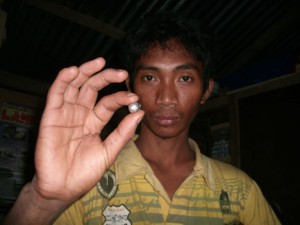 PURE GOLD. A mine worker in goldfield Pantukan shows pure gold weighing three to four grams. The stone's value is enough to feed, clothe and educate his children for a month. (davaotoday.com photo)