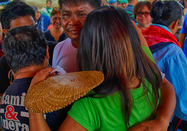 AT LAST, REUNITED. Son, sister, and daughter meet Police Officer 3 Ruben Nojapa Jr. with a longing embrace upon his release 15 days after being held Prisoner of War (POW) by the New People's Army, Tuesday, in Mabini, Compostela valley. (davaotoday.com photo by Medel V. Hernani)