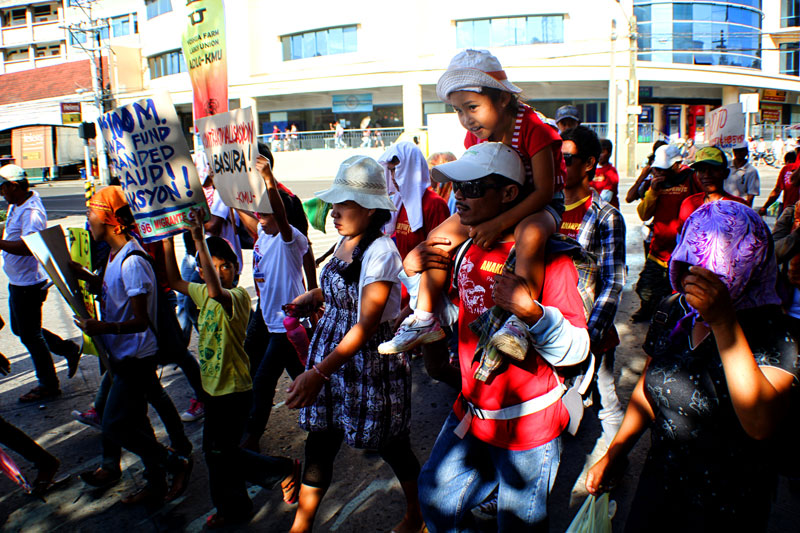 A FAMILY AFFAIR.  The Labor Day rally has become part of the lives of Filipino families who have long demanded for an increase in salaries and wages for immediate, albeit modest, economic relief.  (davaotoday.com photo by Ace R. Morandante)