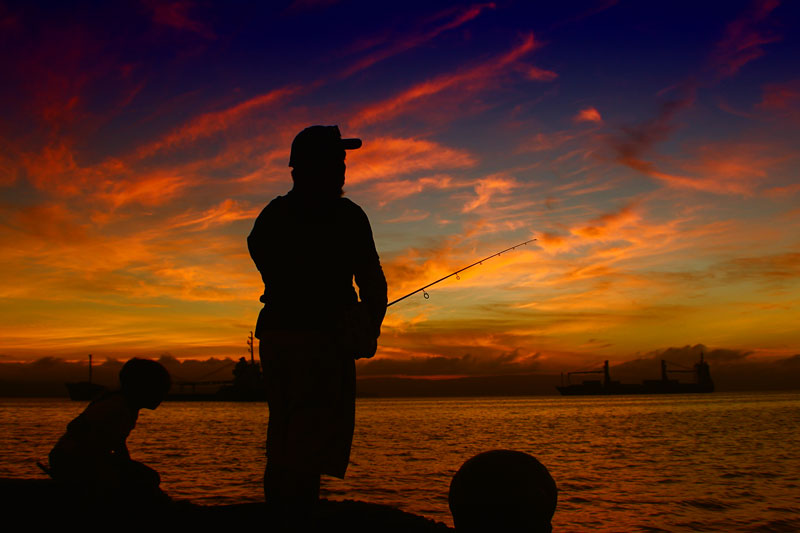 MORNING GLORY.  A man witnesses the breathtaking sunrise in Davao City’s Sta. Ana Wharf while fishing.  (davaotoday.com photo by Ace R. Morandante) 
