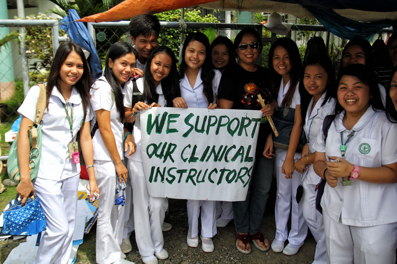 SHOW OF SUPPORT.  Nursing students from Brokenshire College in Davao City express support to their Clinical Instructors (CIs) by visiting the picket line Monday.  The CIs were terminated last May 3 via the Redundancy Program implemented by the school’s Board of Trustees.  The faculty and employees union scored the move as they maintained it’s illegal and a form of union busting.  (davaotoday.com photo by Ace R. Morandante)