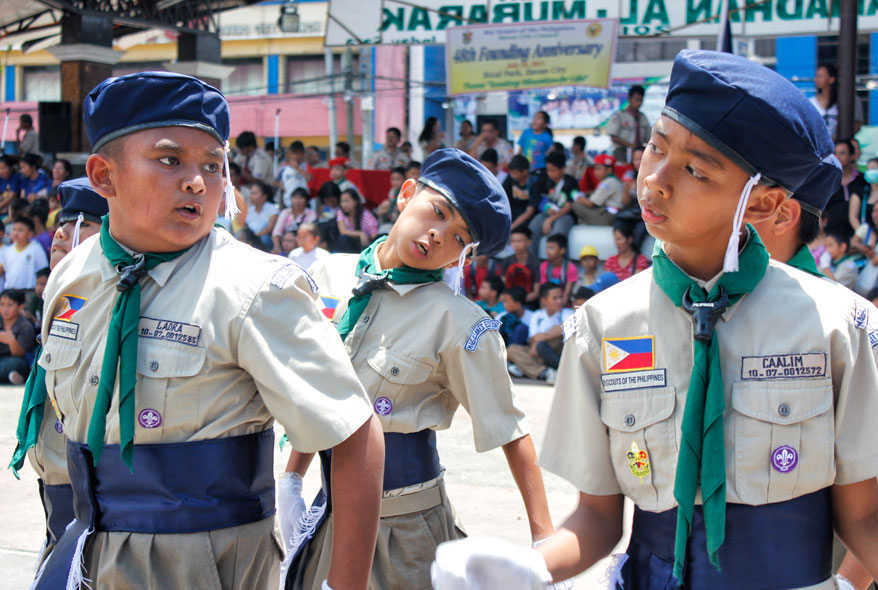 FANCY  STRUT. These boy scouts strut under the morning sun during the 48th Davao Boys Scout Founding Anniversary fancy drill competition in Rizal Park Wednesday. (davaotoday.com photo by Medel V. Hernani)
