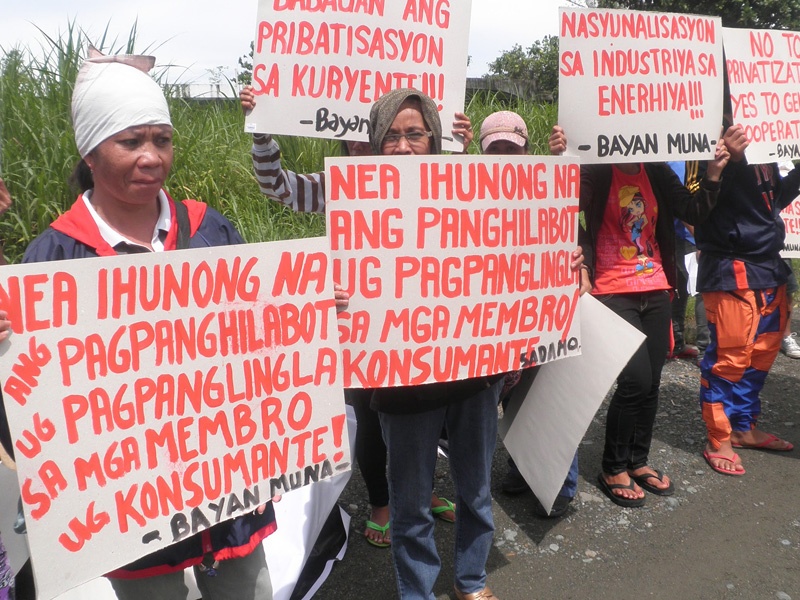 DANECO PRIVATIZATION SLAMMED. Women consumers of DANECO picket the DANECO NEA office in Tagum City during the SONA protesting the purchase of P260 million generator sets and moves to privatize the electric cooperative. (davaotoday.com photo by MART D. SAMBALUD) 