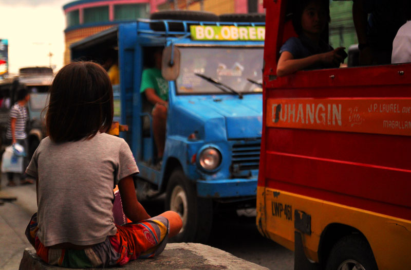 Where to Daang Matuwid?  A Badjao girl seems to be waiting for a ride to take her away from her plight of begging for money in Davao City's busy JP Laurel Avenue.  Poverty remains high in the region despite President Aquino's declaration of 'inclusive growth'. (davaotoday.com photo by Ace R. Morandante)