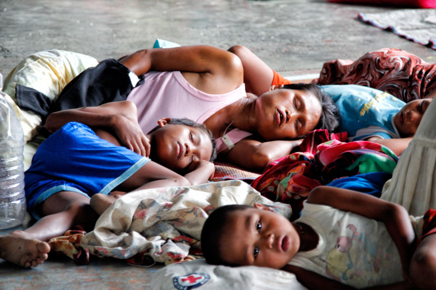 PEACEFUL ONLY IN SLEEPThis Agusanon Manobo family sleeps off their exhaustion in Bankeohan Gym after riding eight hours to Davao City to seek refuge. Some 500 Manobos fled their village in Loreto, Agusan del Sur from military troops 24, and were not welcomed by their governor when they sought his help. (davaotoday.com photo by MEDEL V. HERNANI)
