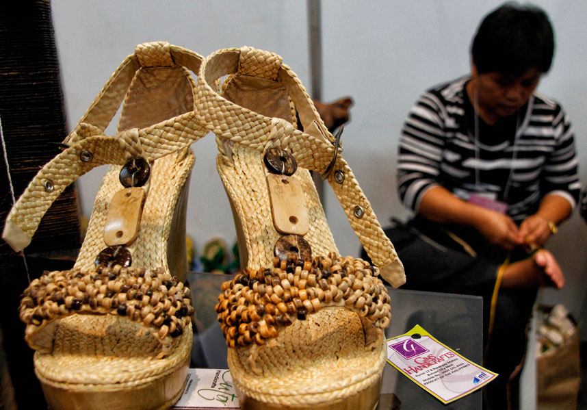 BUTUAN CRAFT  Maylene Cutor of Ivory.07 Arts and Craft from Butuan City, demonstrates how to weave dried water lily into a pair of sandals which they are displaying now in the Mindanao Trade Expo 2013 at Abreeza Ayala Mall until August 25. Cutor said they can produce a maximum of seven pairs of sandals a day. (davaotoday.com photo by Medel V. Hernani)