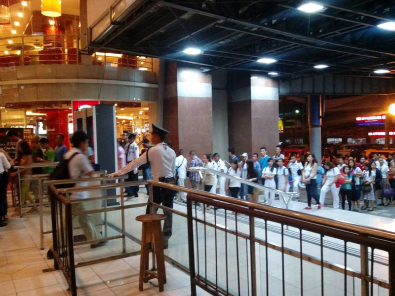A long queue of shoppers passed through metal detectors and individual check of their bags as part of tighter security measures in Gaisano Mall of Davao along JP Laurel Avenue.  The new procedures started days after the mall’s cinema was struck by an improvised bomb last Monday, along with Mayor Rodrigo Duterte’s order for public establishments to have tighter and improved security measures. (contributed photo by Sherwin Desierto)