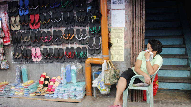 This vendor along the Ponciano – San Pedro junction waits whole day for a customer to buy her wares of slippers and sandals.  The city has enforced a rule on vendors to occupy one-third space along sidewalks to decongest traffic. (davaotoday.com photo by Tyrone A. Velez)