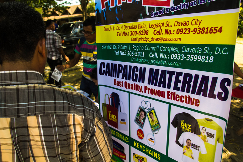 ELECTION BUSINESS TIME A tarpaulin pitching election paraphernalia printing is set up in front of the Comelec office at Magsaysay Park attracting would-be candidates. (davaotoday.com photo by Ace R. Morandante)