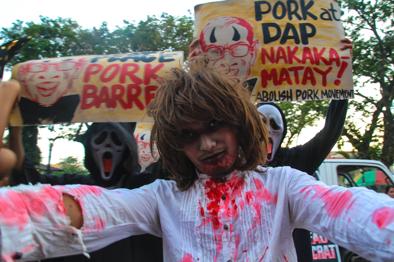 SCARING THE PORK AWAY Activists in Davao staged a Halloween costume protest along San Pedro Street to air their call for the abolition of the President's special funds, DAP and pork barrel funds. (davaotoday.com photo by Ace R. Morandante)