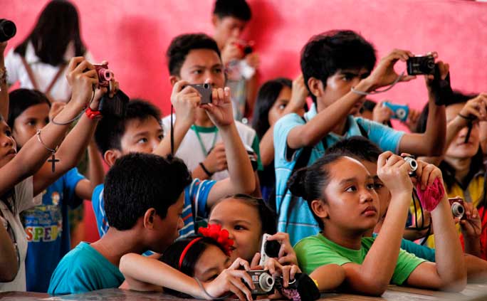 FUTURE PHOTOJOURNALISTS Student journalists learn to capture moments on stage during the Davao Schools Press Conference division-wide competition last Saturday at the University of Immaculate Conception Elementary and HIgh School Campus. (davaotoday.com photo by Medel V. Hernani)