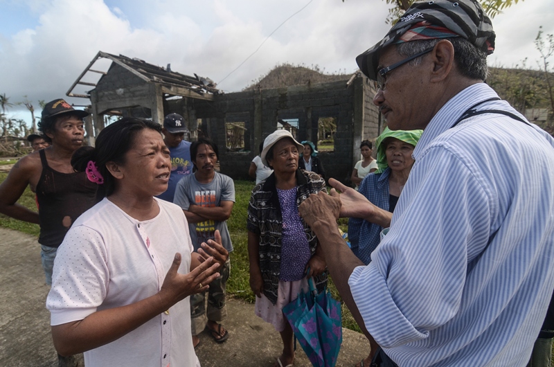 Balsa Mindanao director Francis Morales (right) talks with survivors in Brgy. San Vicente, Tolosa, Leyte. (contributed photo by Ken Bandayanon)