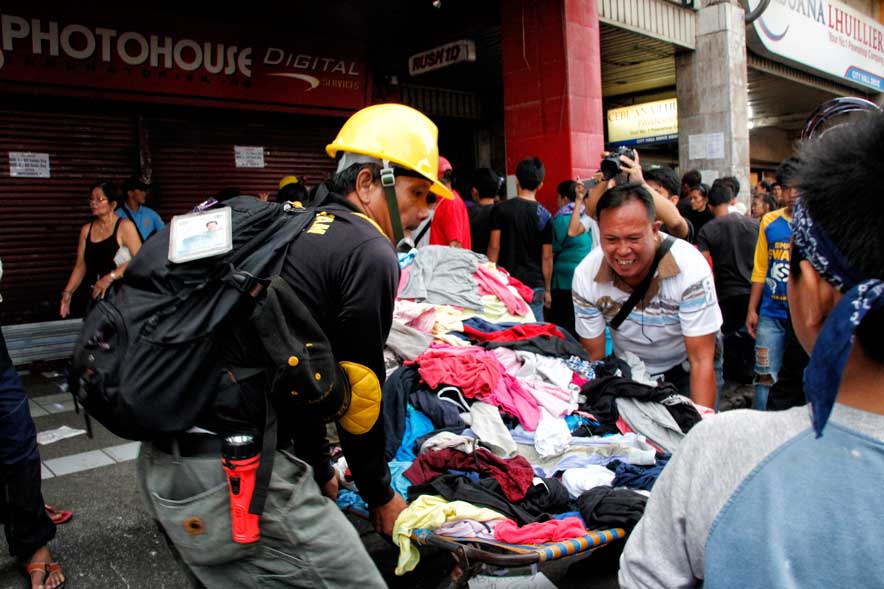 Ukay-ukay clothes get carted away by the city's demolition team operation along City Hall Drive. (davaotoday.com photo by Medel V. Hernani)