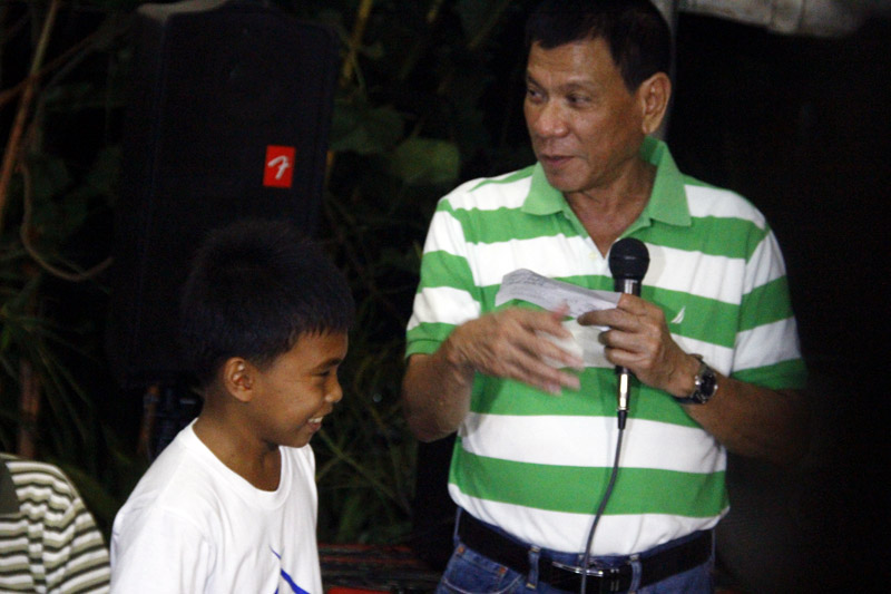 THE MAYOR AND THE BOY Mayor Rody Duterte kids around with a boy from Boys Town Davao, a shelter for abandoned or neglected boys, during their Christmas Party and opening of the Boystown Pizzeria. Duterte played Santa Claus by giving gift certificates and financial assistance to the institution. (davaotoday.com photo by Tyrone A. Velez) 