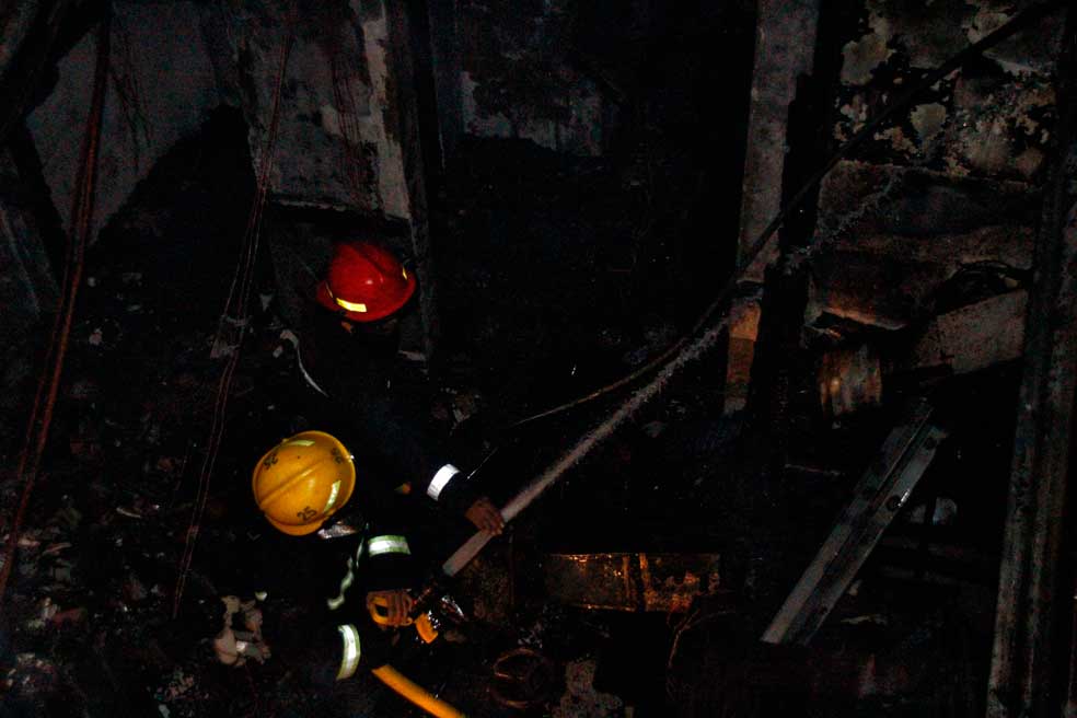 Firefighters putiing out fire from the Jollibee Davao office along Bolton Street. (davaotoday.com photo by Tyrone Velez)