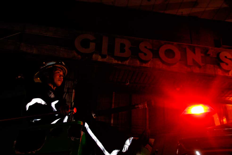 CATCHING FIRE. A firefighter comes out of the Jollibee Davao office in Bolton Street which burned down Thursday night due to "short circuit" of equipment. (davaotoday.com photo by Medel V. Hernani)
