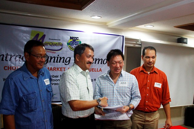 HAND SHAKE A lease agreement to build NCCC Choice Supermarket at Commercio Marquella at Tigatto-Mandug area was signed Friday between LTS Supermarket President Javelin Lim (2nd right) and Northbank Holdings Corp President Simeon Marfori II.  The supermarket will rise next year to provide goods and services to some 30,000 residents in the area. (davaotoday.com photo by Medel V. Hernani)