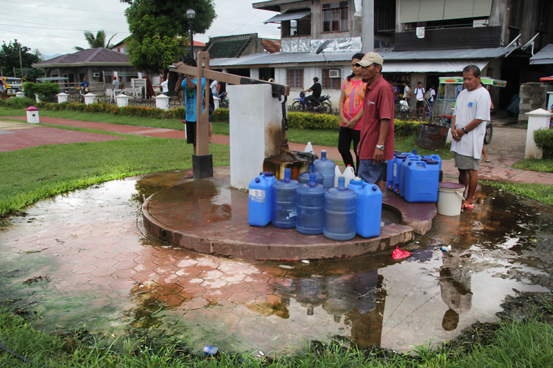 A year after Typhoon Pablo struck Davao Oriental, residents in Cateel still have to line up for water at this well in Poblacion at 10 pesos per container. Residents said that wells in their relocation center are unsafe and smelled of rust. (davaotoday.com photo by Ace R. Morandante)