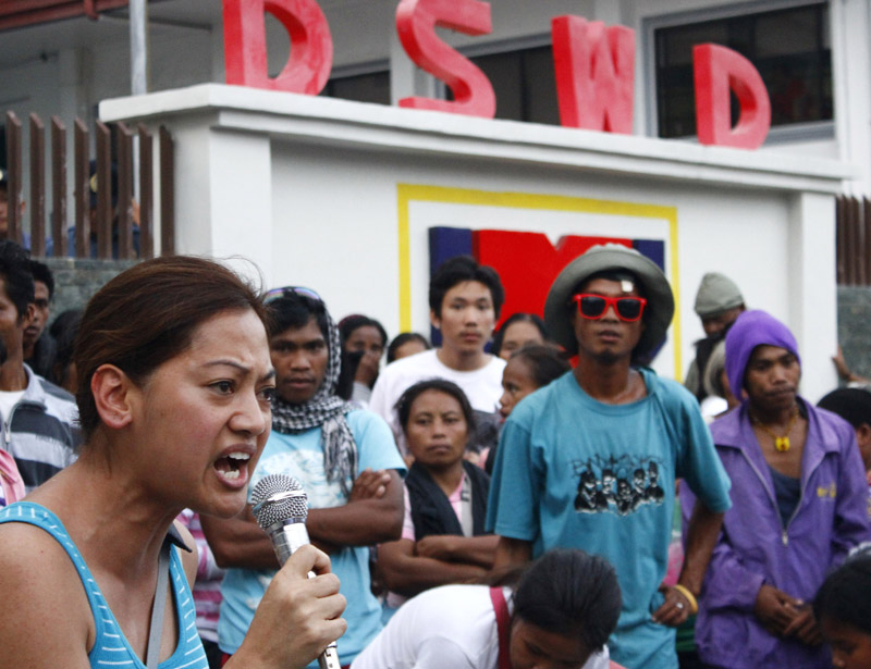 Donna Demina of Gabriela USA expresses solidarity with Typhoon Pablo survivors in a rally at the DSWD regional office in Davao criticizing government's neglect in rehabilitating houses and farms. (davaotoday.com photo by Earl O. Condeza)