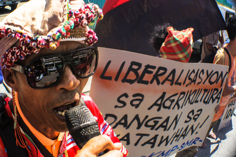 ANGRY AT SMUGGLING. A farmer from Davao joins a rally in front of the Department of Agriculture regional office Tuesday calling for the stopping of trade liberalization which ushers rice smuggling to the detriment of local farmers. (Ace Morandante/ davaotoday.com)