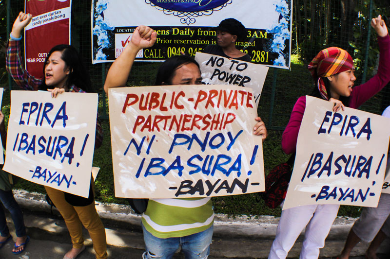 SCRAP EPIRA. Activists staged a picket at the entrance of Waterfront Hotel during a public consultation Thursday on amendments on the EPIRA law, in which groups such as Bayan called for its repeal as it pushes monopoly of corporations on the energy sector. (Ace R. Morandante/ davaotoday.com)