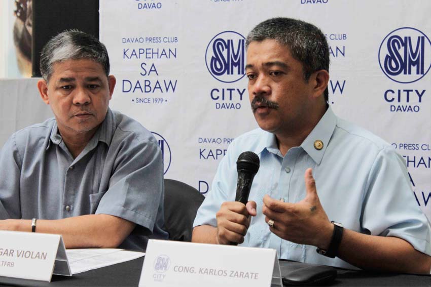 Bayan Muna Representative Carlos Zarate (right) raises concern on the government's move to penalize 'colorum' passenger vehicles saying it would not remedy the traffic problems in key cities in the country. At left is Land Transport Regulatory and Franchising Board regional spokesperson Edgar Violan.
