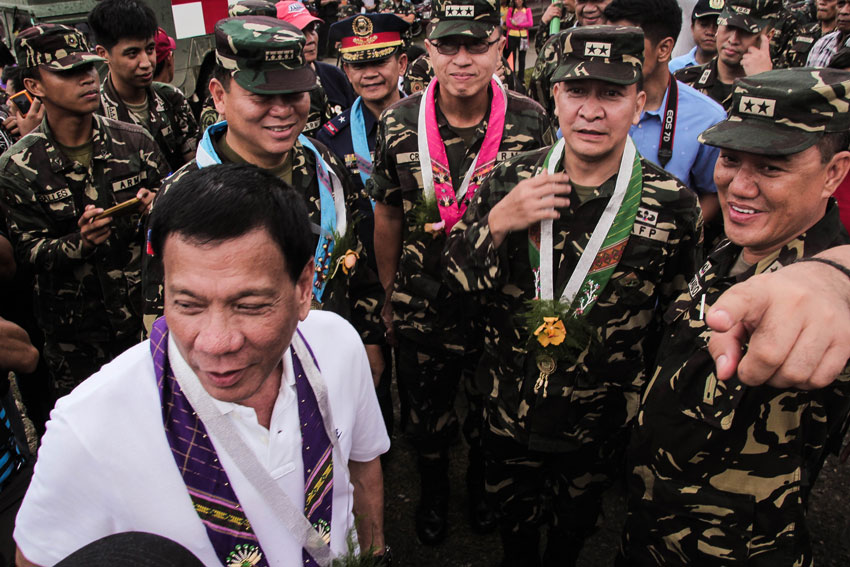 Mayor Rodrigo Duterte in a light moment with Armed Forces Chief of Staff Gen. Emmanuel Bautista (second, right) and Eastern Mindanao Command General Arnel Bernardo (right) during a peace ceremony in Paquibato District on June 12.