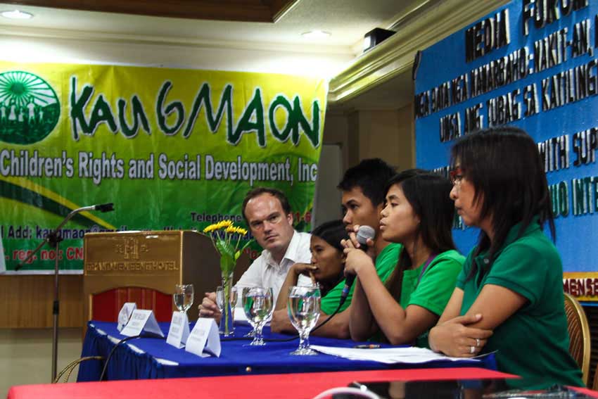 During Kaugmaon Foundation's forum on child labor action Tuesday, child peer counselor Hazel Cañete shares her experience as a fertilizer packer as AWO International Southeast Asian Region Director Martin Liberantz (left) listens. 