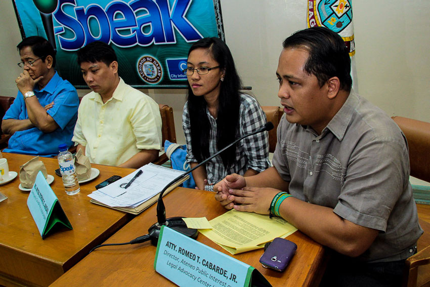 Lawyer Romeo Cabarde, Jr. (right) announces the Ateneo Legal Aid office is housing the Justice Assistance Center to facilitate claims of Martial Law victims for compensation every Monday, Wednesday and Friday afternoons before August 4, 2014.