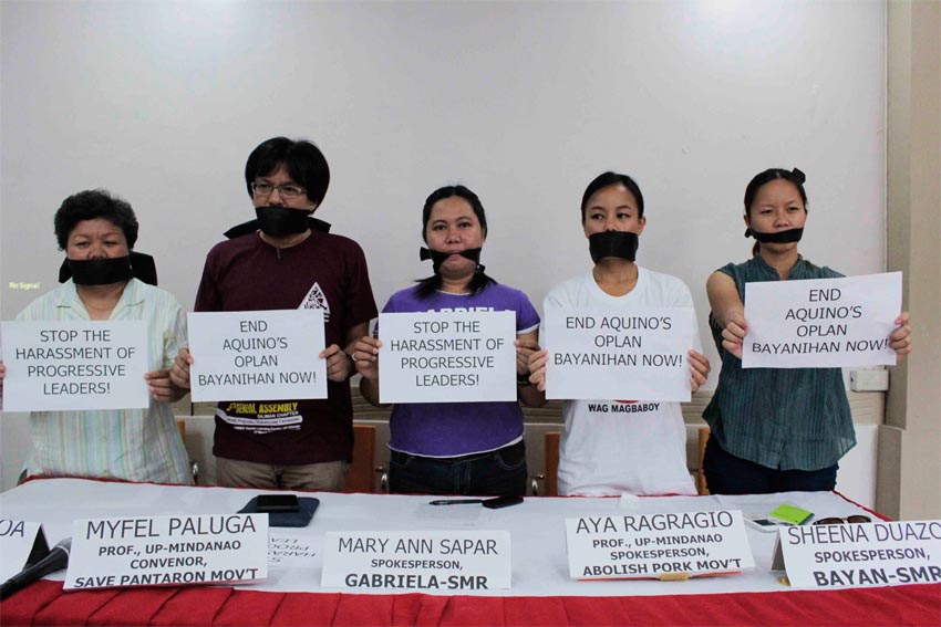 University of the Philippines Mindanao professors Myfel Paluga and Andrea Ragragio (middle) are joined by a co-teacher and activists in exposing alleged intelligence agents tailing them from their research work in General Santos City all the way to Davao City last Saturday.