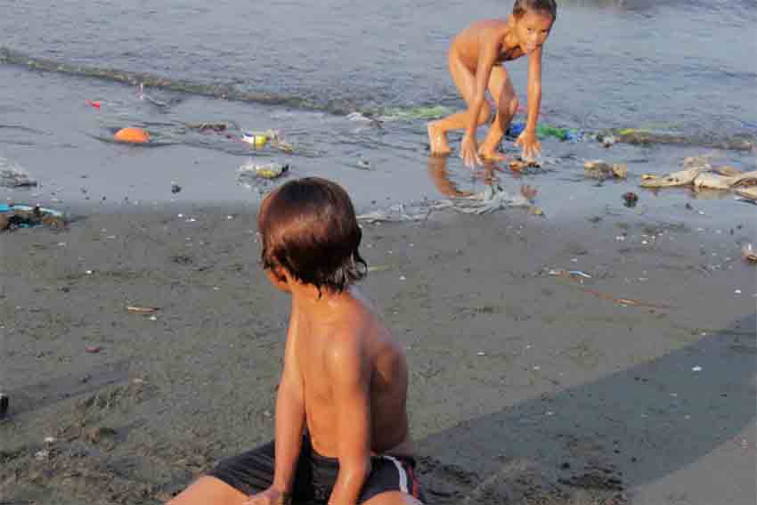 Boys from Purok Soliman, Boulevard frolic in Santa Ana Wharf unmindful of the possible infections brought by the murky waters.