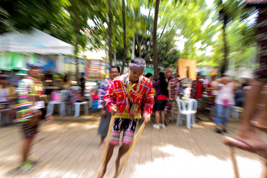 A Lumad keeps his balance at the wooden stilt, made from tree branches, as he races to the finish line in the tribal festival of games featured in this year's Kadayawan festival of Davao City.