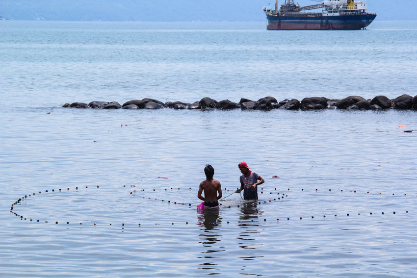 These two Badjaos (Sea gypsies) try to catch some fish at Isla Verde for their daily sustenance. 