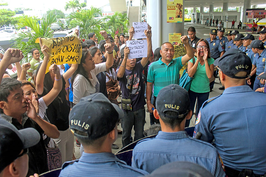 Protest Action led by progressive groups Bayan Southern Mindanao Region inside SM Lanang in time for Pres. Aquino's keynote during the Philippine Business and Social Progress forum at the SMX Convention Center today. (contributed photo by Jazzania Necosia)