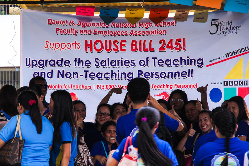 THUMBS UP. Teachers pose behind the banner calling for salary increase. House Bill 245 which was filed by ACT Teachers Partylist seeks to increase the minimum salaries of teaching and non-teaching personnel in public elementary and secondary schools. (Ace R. Morandante/davaotoday.com)