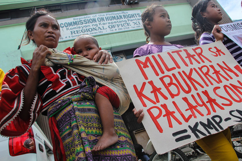 A tribal mother and child join the rally in front of the Commission of Human Rights Region XI demanding the removal of encampment of the Army's 66th IBin there community. (Ace R. Morandante/davaotoday.com)