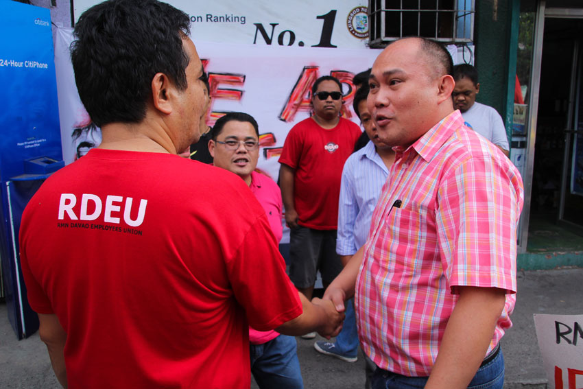 ON THE SCENE. Attorney Joffrey Suyao (right), Davao regional director for labor, arrives at the strike camp of the Radio Mindanao Network (RMN) Employees Union to hear our their grievance and offer to help mediate for the re-opening of collective bargaining with the RMN management. (Ace R. Morandante/ davaotoday.com)