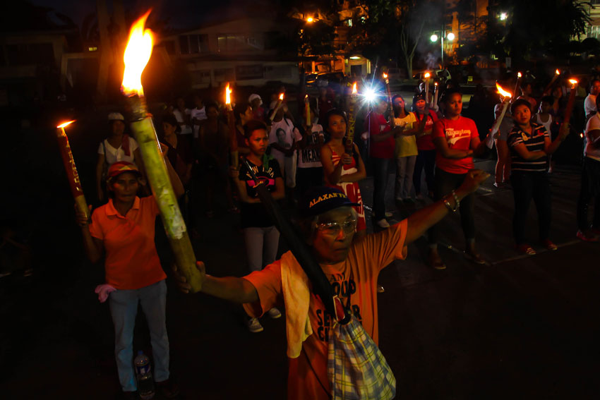 Womens group Gabriela light up torches in commemoration of National day of women's protest at Rizal park. (Ace R. Morandante/davaotoday.com)