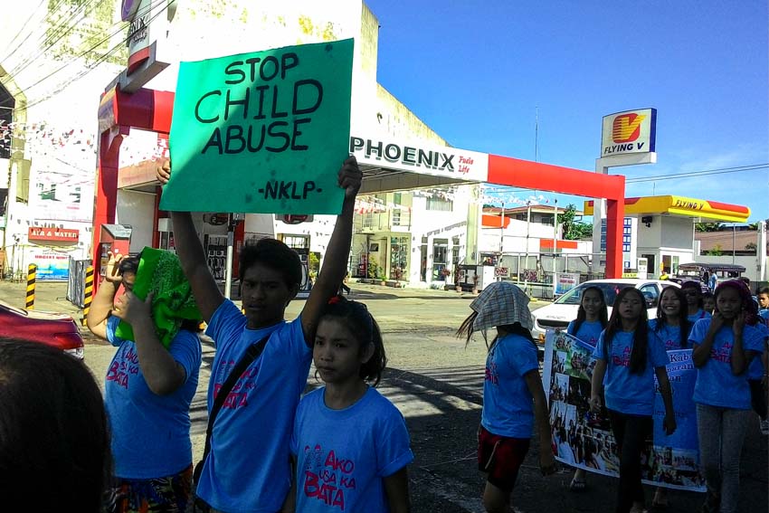 Children march around Davao City's downtown streets to call for end to child trafficking, child labor and other issues affecting children. (John Rizle L.  Saligumba/davaotoday.com)