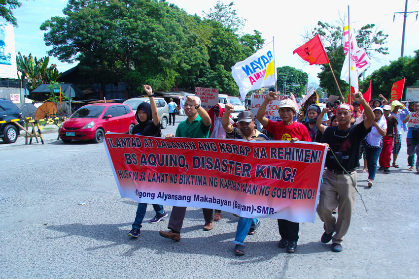 BE TRANSPARENT. On the 2nd year of Typhoon Pablo, members of Barug Katawhan and other support groups march to the office of the Department of Social Welfare and Development in Davao City to demand report on how funds were spent particularly for the housing program in Pablo stricken areas of Compostela Valley and Davao Oriental.  (Ace R. Morandante/davaotoday.com)