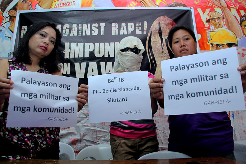 Rape victim "Jessa" 16 years old (center), appears before a press conference Tuesday to demand that her alleged perpetrator Pfc. Benjie Blancada, who is a member of the Philippine army's 84th Infantry Battalion, be punished. She is flanked by Gabriela leaders Dr. Jean Lindo (left) and Mary Ann Sapar (right). (Ace R. Morandante/davaotoday.com)