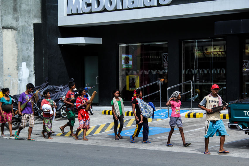 TRIBAL CAROLERS. From the hinterlands of Malabog, Paquibato district, these tribal Ata- Manobos walk around the streets of downtown Davao City and its subdivisions to seek kindhearted residents of early Christmas gifts. The city government of Davao provide them temporary shelters while they stay in the city during the holiday season . (Ace R. Morandante/davaotoday.com)