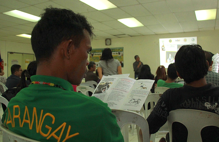 AWARENESS CAMPAIGN.  A barangay official reads a primer on rabies during the citywide health forum dubbed as National Rabies Prevention Control Program of Davao City, Wednesday, at the Sangguniang Panlungsod. (Ace R. Morandante/davaotoday.com)