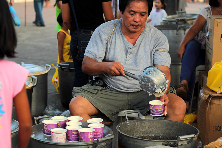 A man who serves a cups of porridge for free located at Rizal Park in the City. Around 40 large pots of porridge serves everyday for the people given by the Local Government Units of Davao. (Ace R. Moradnante/davaotoday.com)