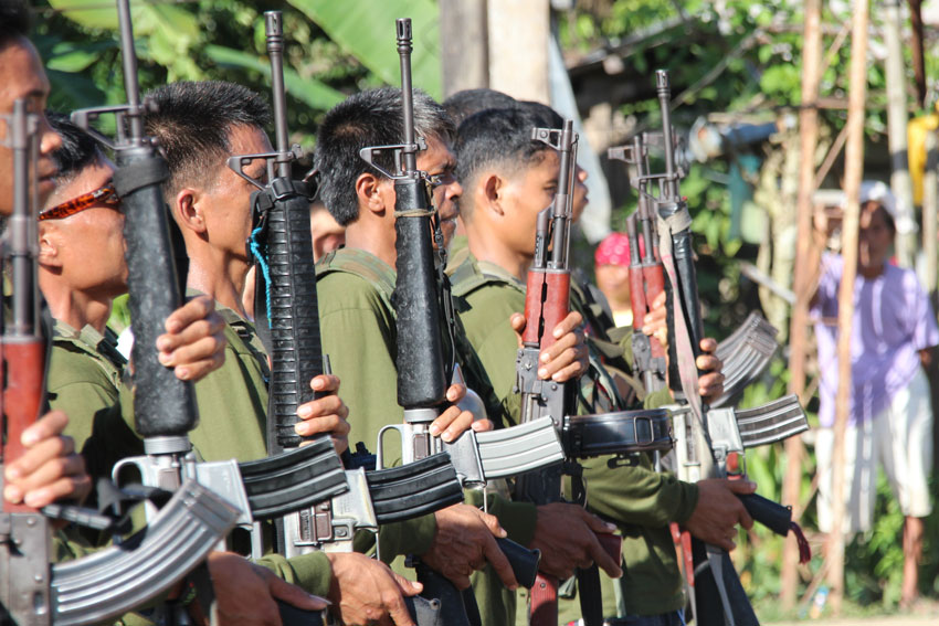 Members of the New People's Army sing the Internationale before the release of the "prisoners-of-war" Cpl. Benjamin Samano and Pfc. Alvin Ricarte. (Johannes Realista Garado/davaotoday.com