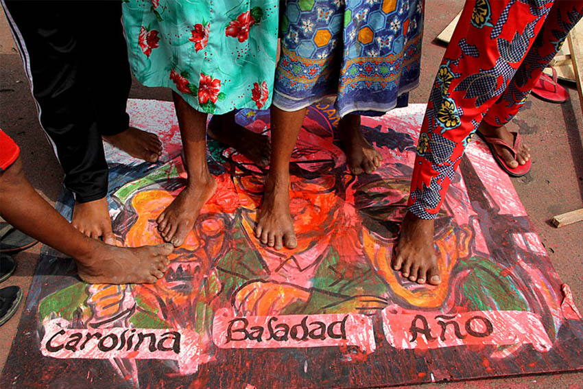 Tribal protesters from across the Davao Region step on images of military generals to demonstrate their indignation over the string of killings of tribal residents suspected or mistaken for New People's Army guerrillas. Tribal communities join the commemoration of the International Human Rights day in Davao City. (Ace R. Morandante/davaotoday.com)