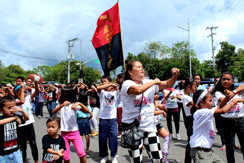 Women and children dance on the streets during the One Billion Rising campaign here led by Gabriela.  The traffic flow of vehicles was stopped for 5 minutes at the juncture of Magsaysay Ave. and Quimpo Boulevard.   