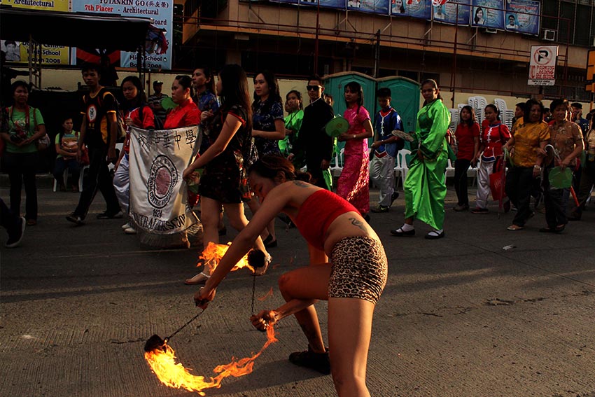 A teenage girl and a man performing a fire dance is one of the attractions during the welcoming of the Chinese New Year in Davao. (Medel V. Hernani/davaotoday.com)